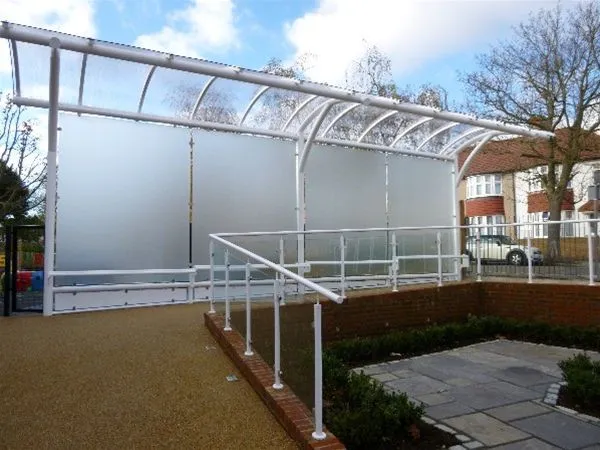 Curved Polycarbonate Free Standing Walkway with Integral Satin Glass Vertical Panels and Anti Vandal Seating Rails Sunbury Project